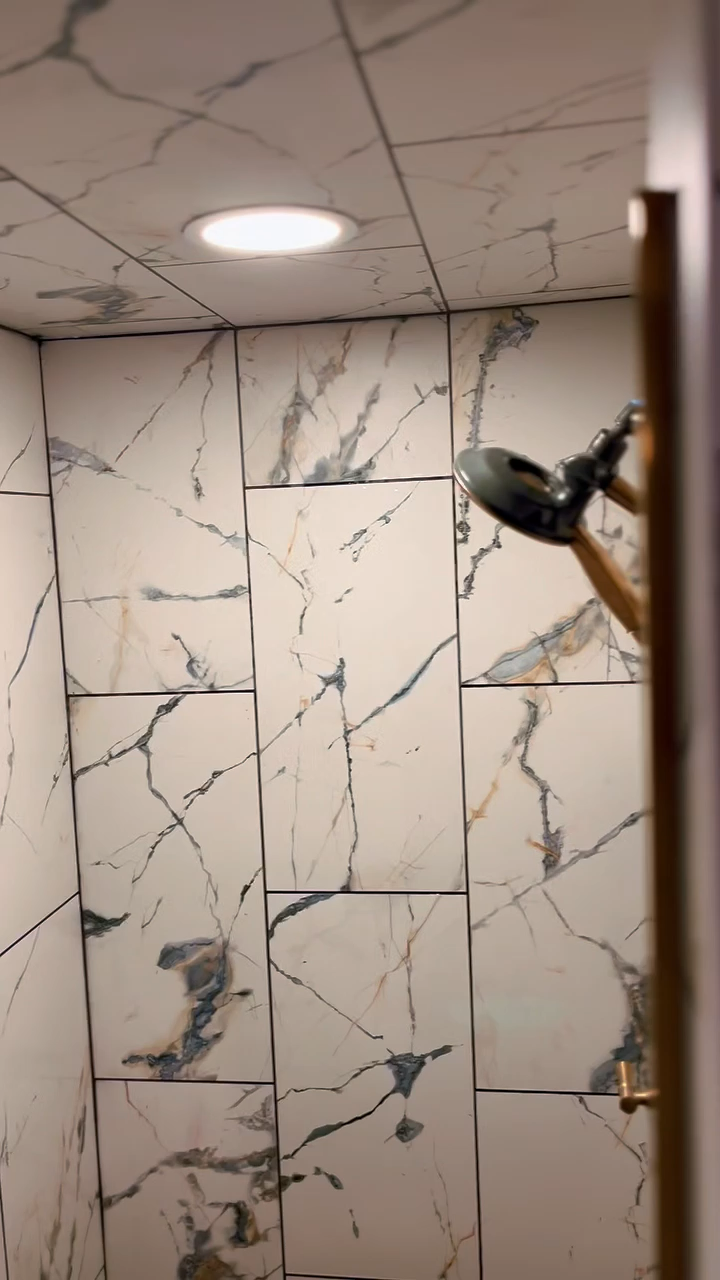 Bathroom remodel detail with warm tile, soft lighting, and refined finish work in San Antonio.